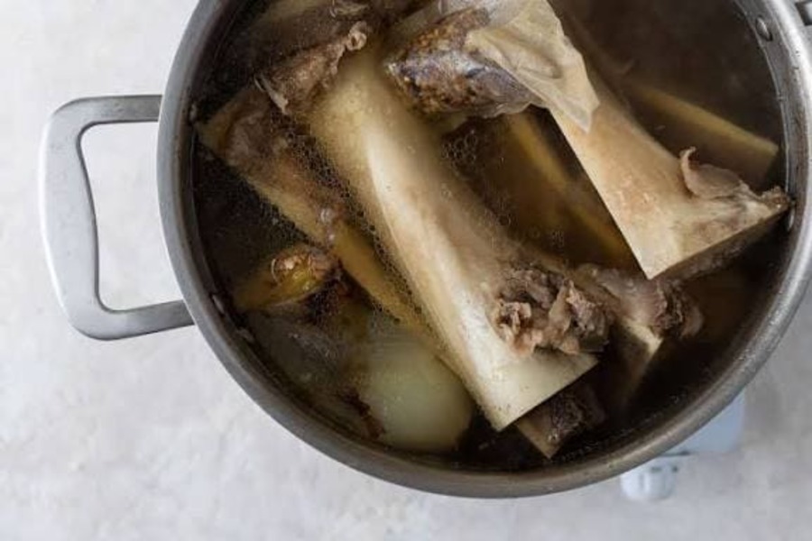 Vietnamese pho broth simmering with beef bones and aromatic spices